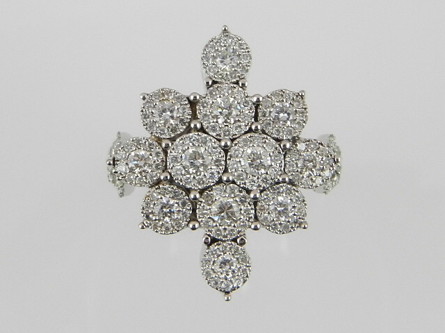 An unusual white metal diamond cluster ring, fashioned as a snowflake, the diamonds of approx. 1.