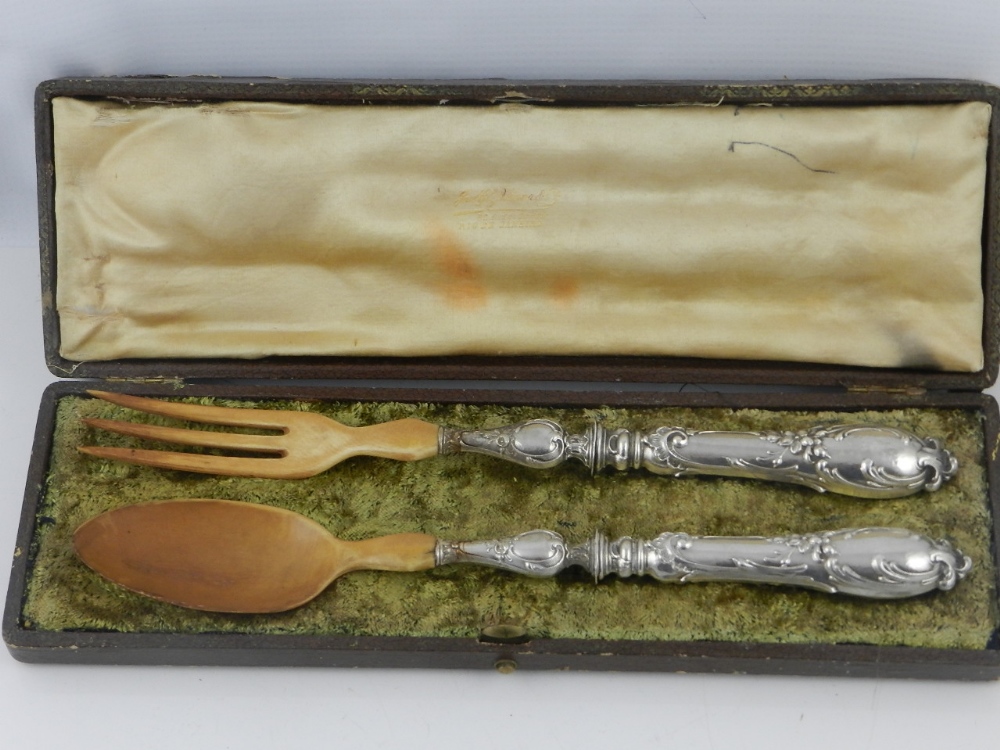 A cased pair of early 20th century French silver-handled ivory mounted salad servers.