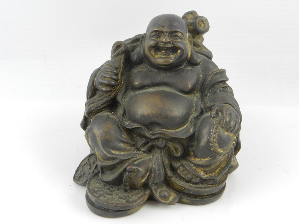 A 19th century Chinese parcel gilded bronze study of a seated Buddha with napsack, H. 8 cm.