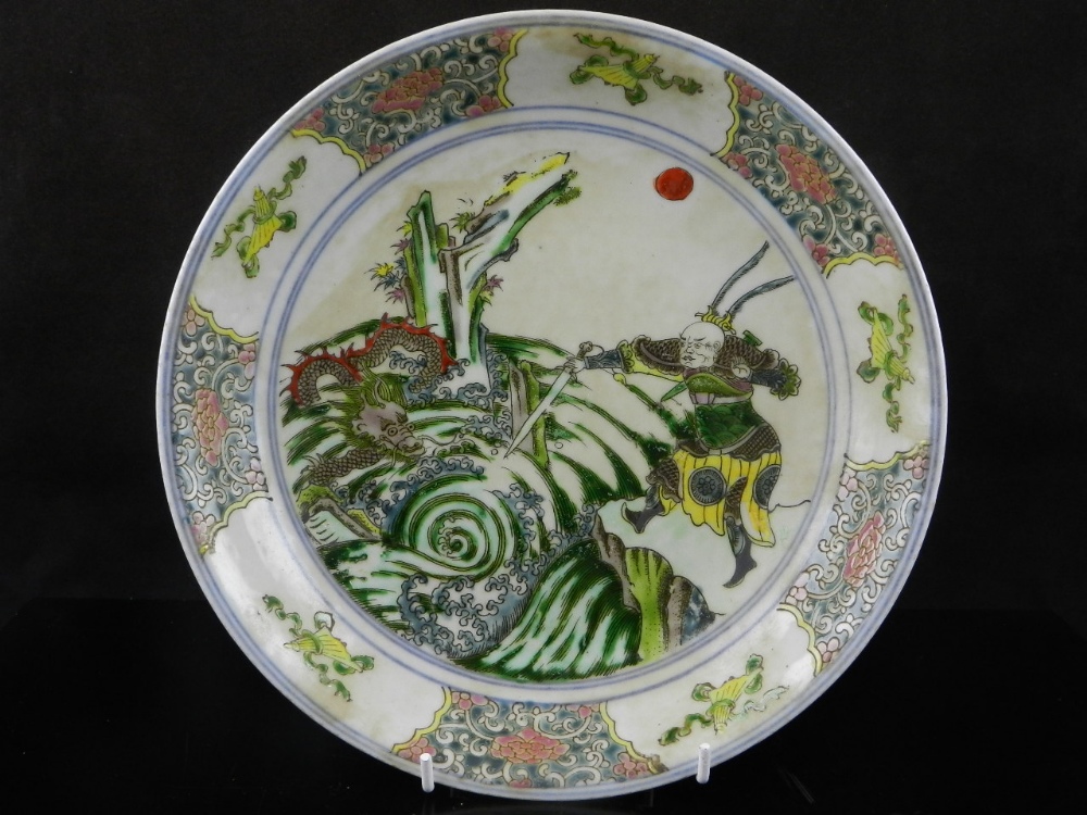 A Chinese famille vert shallow dish, decorated with warriors and dragons.