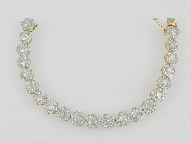 A fine and rare diamond articulated line bracelet, fashioned as 21 open work round links centred