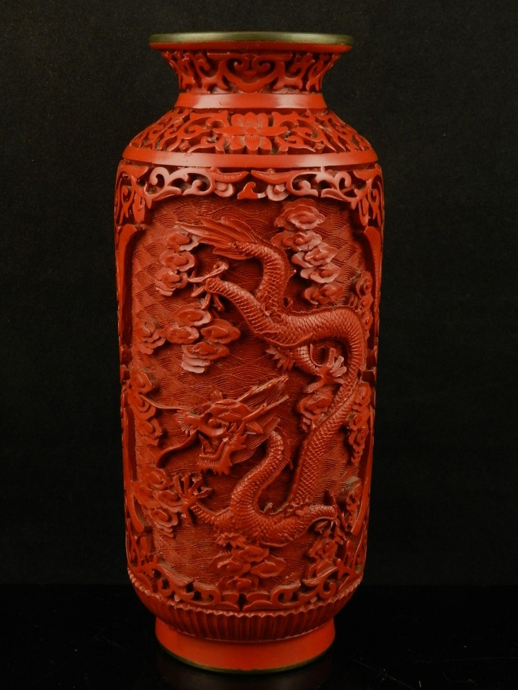 A Chinese cinnabar lacquer cylindrical vase, carved in deep relief with dragons, stylised clouds and