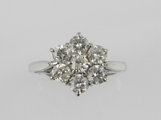 A 9ct white gold seven stone diamond cluster ring.
