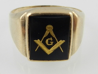 Of Masonic interest. A yellow metal and black enamelled signet ring, centred with set square and