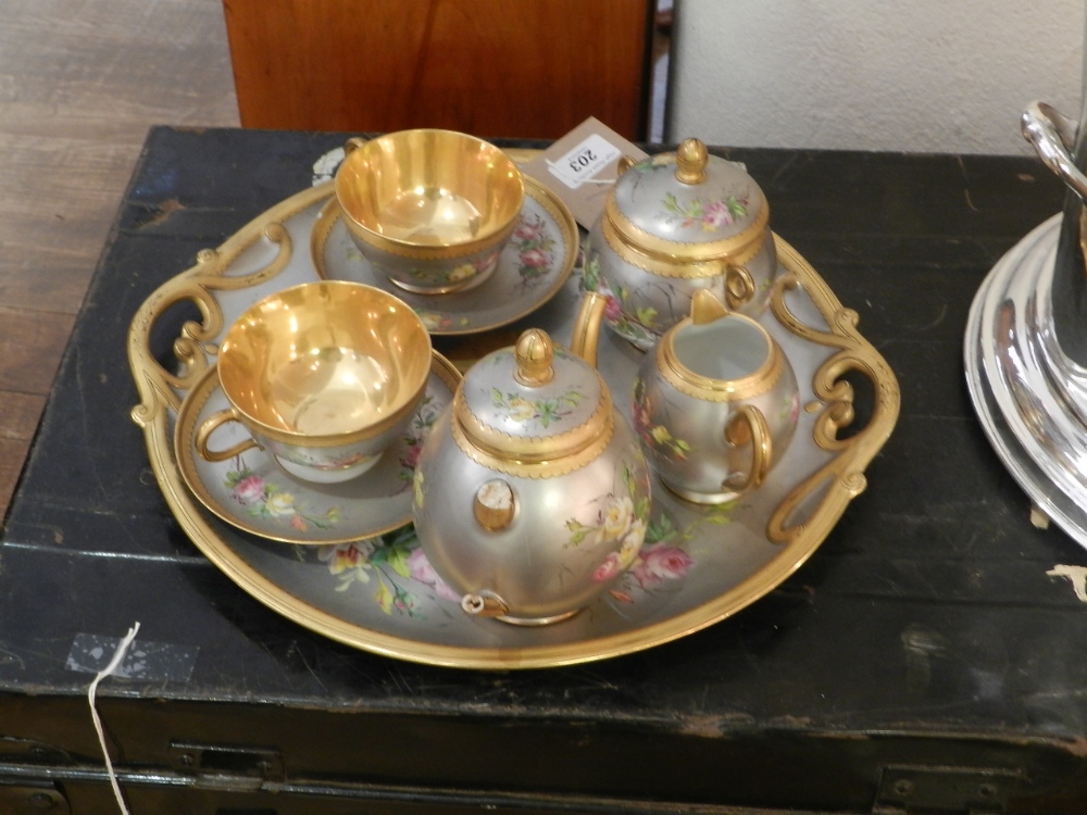 A late 19th century Vienna porcelain cabaret set, hand painted floral decoration on a silvered