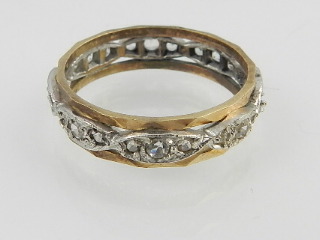 A bi-metallic diamond set eternity ring, mid 20th century.