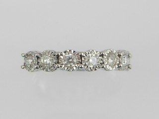 A 9ct white gold seven stone diamond ring, the brilliant cut stones of .50 carats combined.