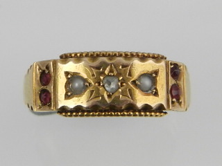 A late Victorian 15 carat yellow gold dress ring, centred with a diamond flanked by split seed