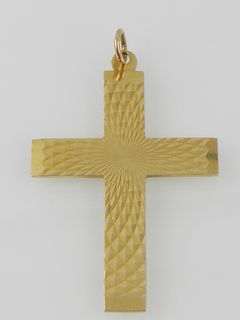 A 9ct yellow gold crucifix, engine turned with radiating lozenge designs, bears inscription to