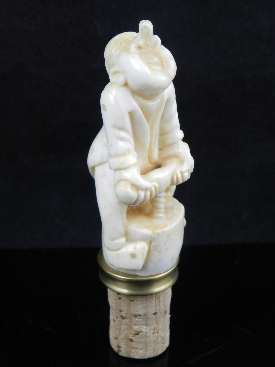 A carved bone bottle stopper. H: 10.5cm