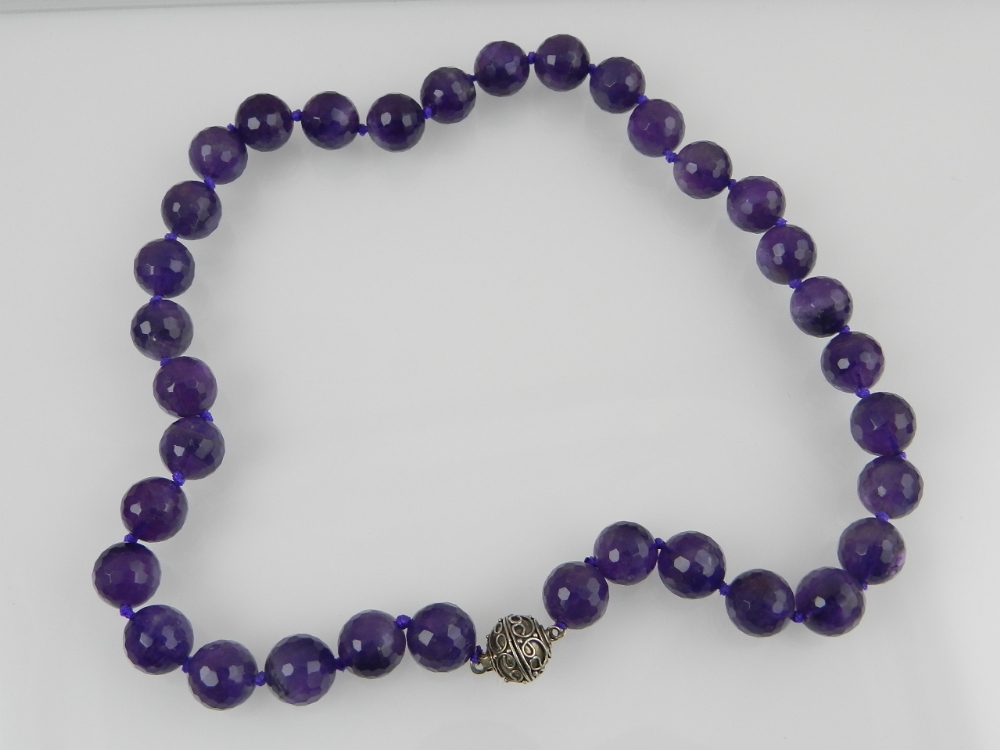 A rock amethyst beaded necklace, with faceted beads and white metal clasp.