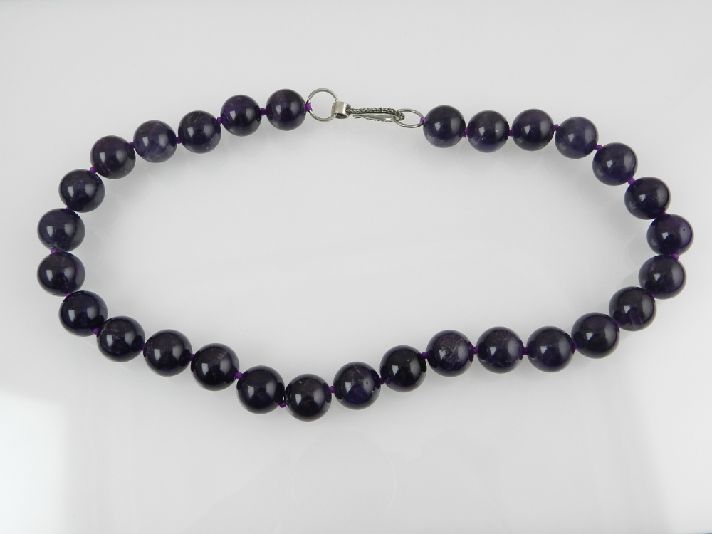 A rock amethyst beaded necklace with white metal clasp.