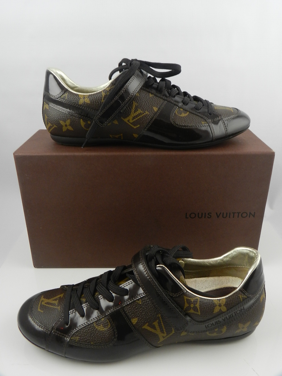 Louis Vuitton, Paris. A pair of 'Globe Trotter' sneakers, brown monogram and patent leather lace-ups