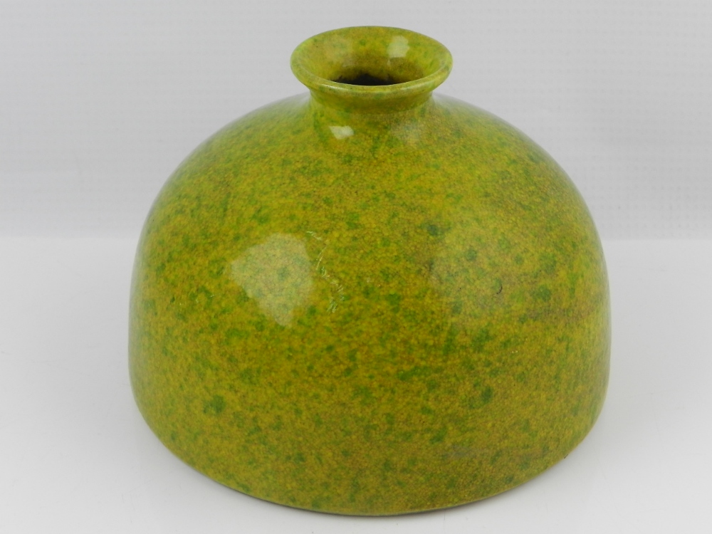 A Chinese green and yellow glazed vase of rounded form with flat base and circular everted aperture.