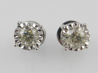 A pair of white metal diamond ear studs, having illusion set brilliant cut diamonds of approx. 1.