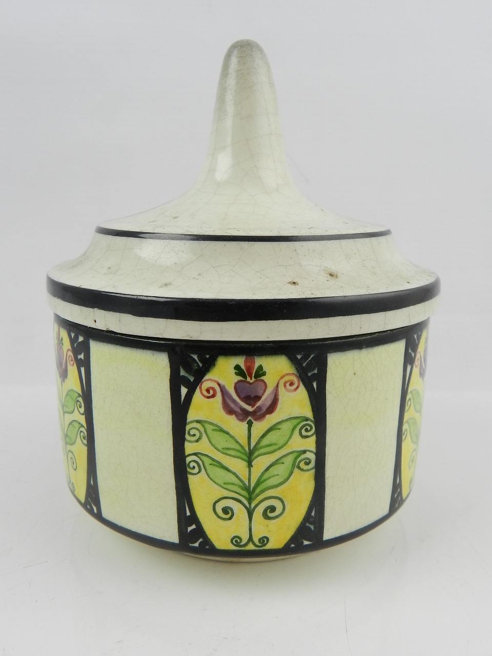 An early 20th century Weiner Werkstatte pottery jar and cover, decorated with painted panels of