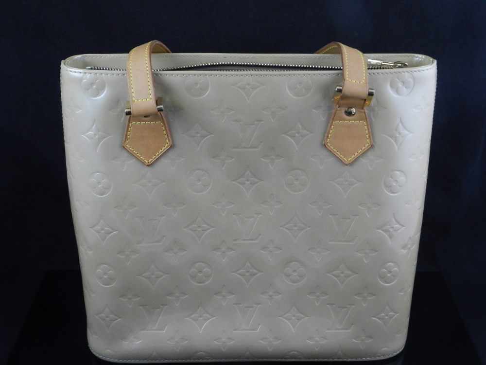 Louis Vuitton, Paris. A ladies patent gold leather handbag monogrammed and decorated with flower