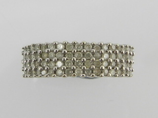 A white metal pave diamond set half eternity ring, the shank stamped 9K.