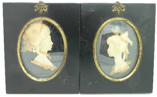 Two wax portraits, in ebonised frames