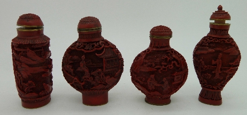 Four modern carved cinnabar snuff bottles