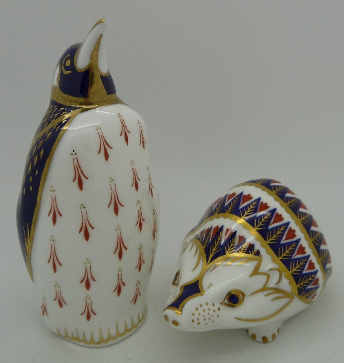 Two Royal Crown Derby paperweights, Penguin and Hedgehog with silver stopper
