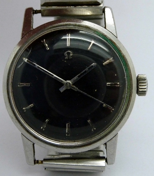 A gentleman`s stainless steel Omega wristwatch, the circular black dial with raised hourly markers