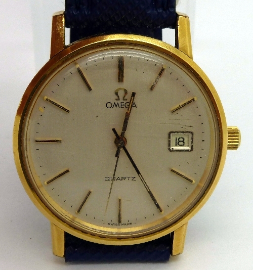 A gentleman`s gold plated Omega quartz wristwatch, the circular champagne dial with raised hour