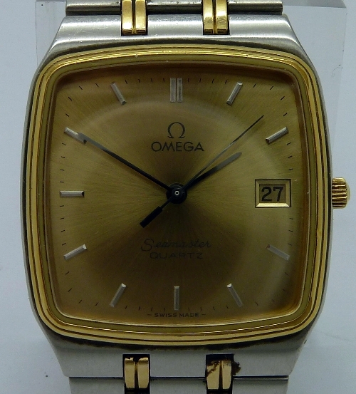 A gentleman`s stainless steel Omega Seamaster quartz wristwatch, the rectangular gold dial with