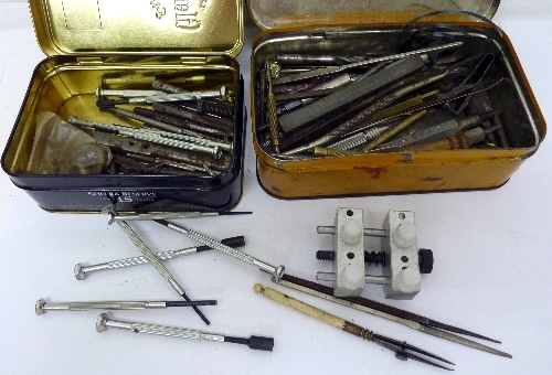 Three tins of watchmakers tools