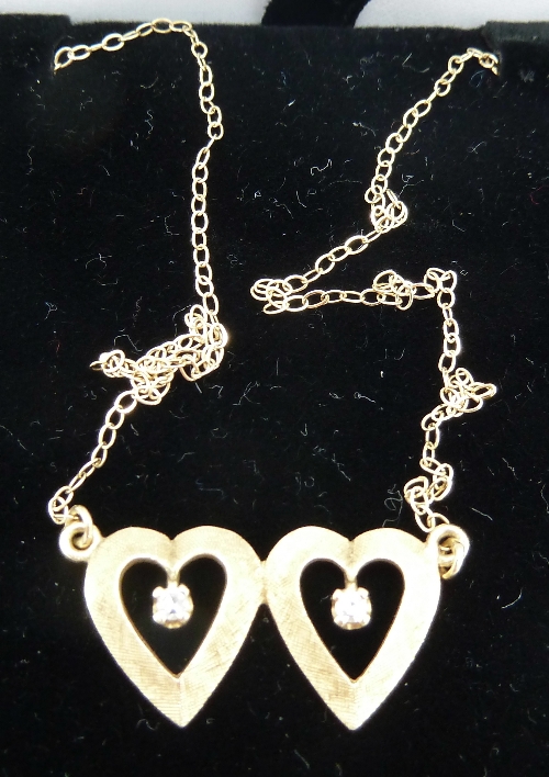 A 14ct gold double heart and white stone