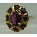 A 9ct gold and garnet cluster ring, weig
