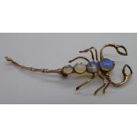 A yellow metal and opal scorpion brooch,