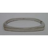 A 9ct white gold bangle, weight 14.1g