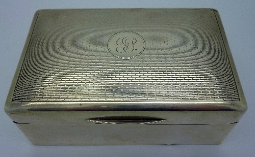 A silver cigarette box, width 14cm, with initials