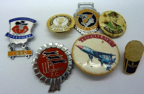 A collection of seven badges including Dan Dare, Thunderbirds and Nottingham Speedway