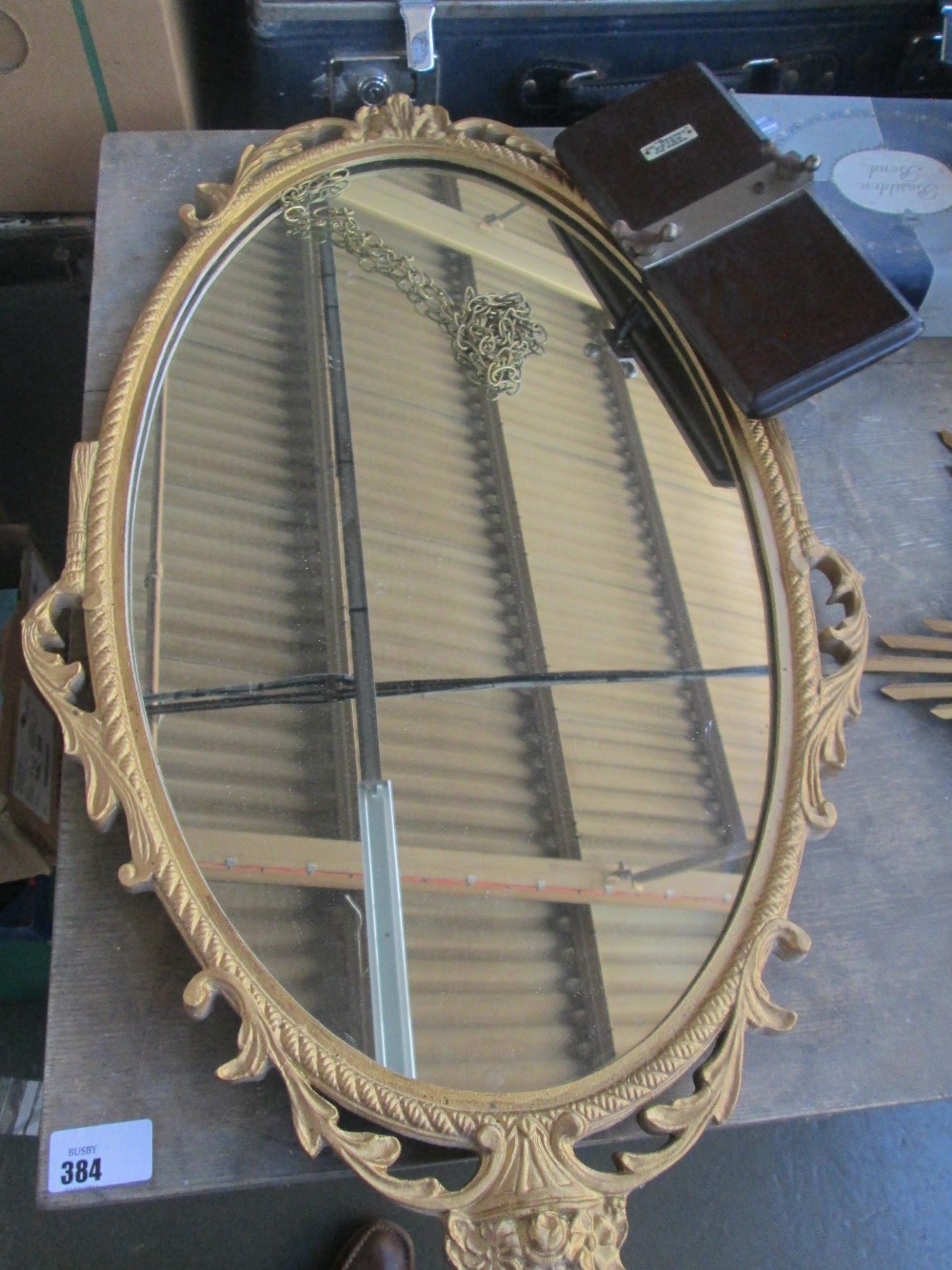 A vintage decorative gold wall mirror 67cm high x 37cm wide and The "Beaver" Peter Tie Press.