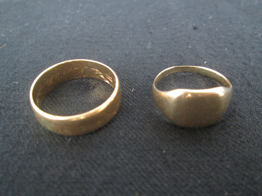 An 18ct gold mens wedding ring, 5g, with another gold ring, probably 9ct, markings rubbed, 3g