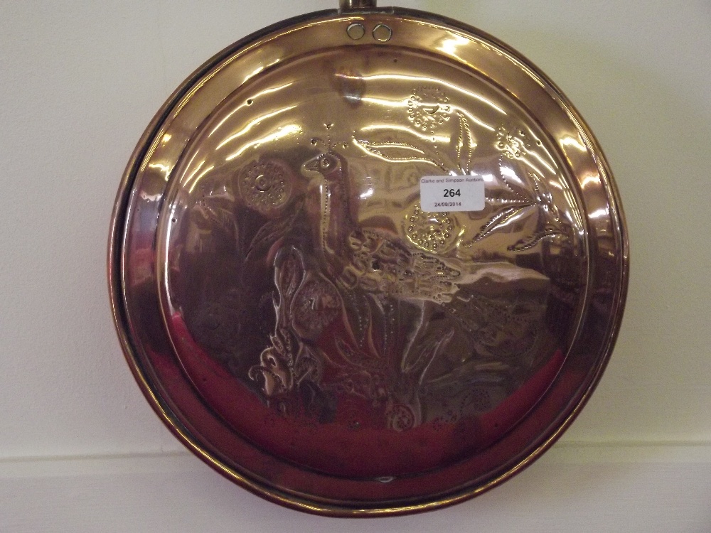 A Victorian copper warming pan, the lid having pin prick decoration of a peacock amongst flowers,