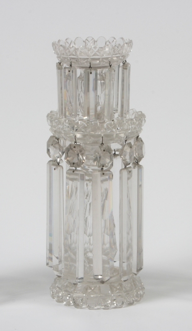 A 19th Century cut glass baluster candle stick, having castellated sconce and drip pan, hung with