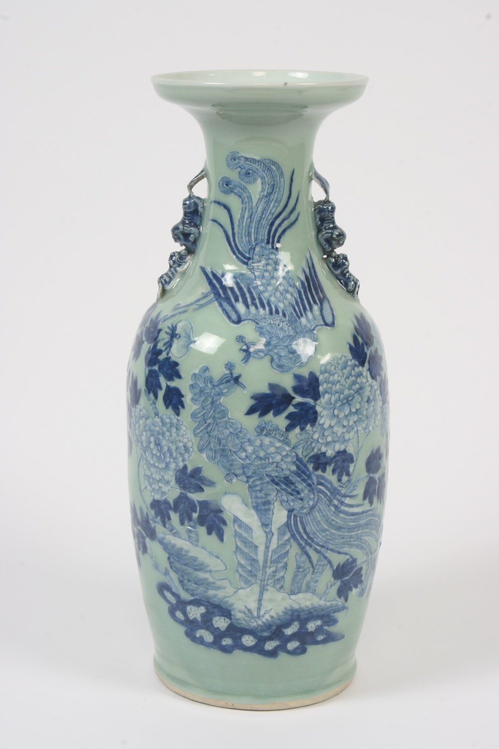 A Chinese baluster vase, decorated with exotic birds and foliage on a celadon ground, flanked by Dog