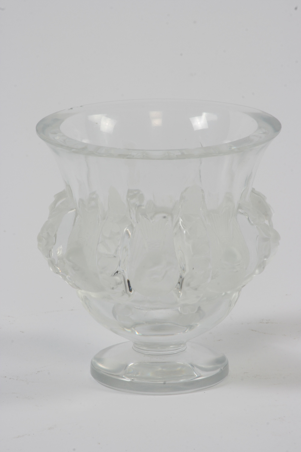 A Lalique glass vase, of urn shape, decorated with birds, raised on a circular spread foot, 13cm