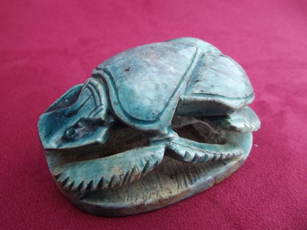 An Egyptian antiquity in the form of a turquoise glazed ceramic scarab