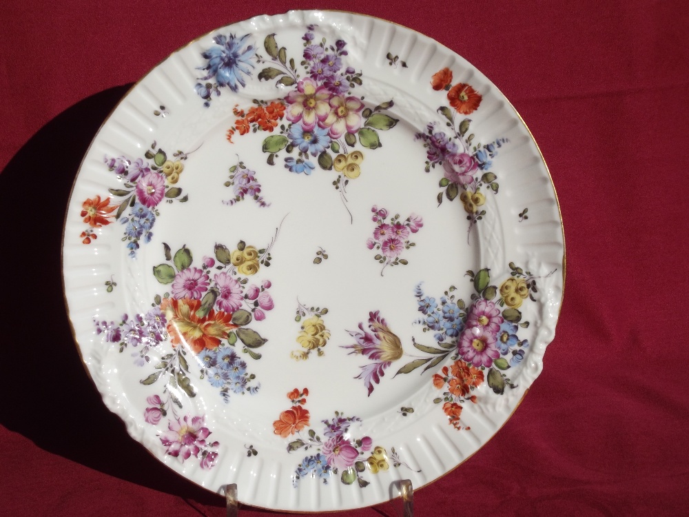 A late 19th Century German porcelain cabinet plate, with all over floral design within cartouche and