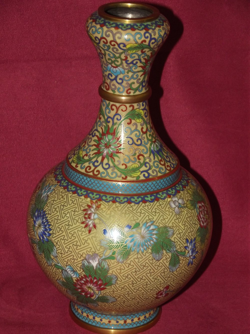 A cloisonne baluster vase, decorated with prunus and scrolling foliage, 24cm high