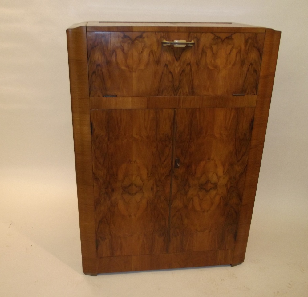 An Art Deco walnut cocktail cabinet, the upper section with mirrored interior, 118cm x 83cm