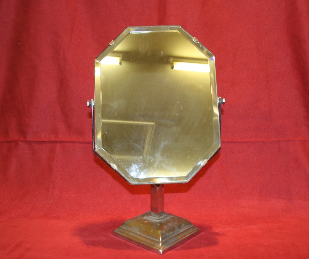 An Art Deco frameless bevel edged swing frame mirror, raised on chromed brass stand 43cm