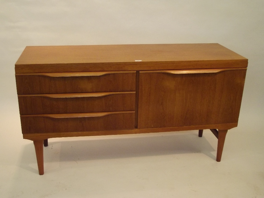 A teak sideboard, fitted drop front cupboard beside three drawers 73cm x 134cm