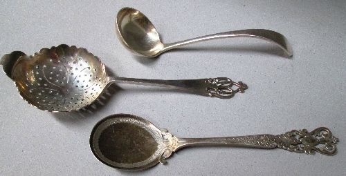 A silver tea strainer with shaped edge bowl and pierced handle, Sheffield 1937, a jam spoon with
