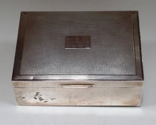 A rectangular silver cigarette box with engine turned lid 11.5cm x 8.5cm