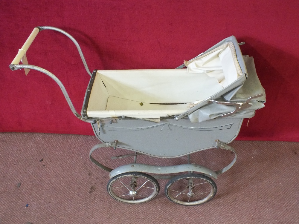 A vintage four wheeled grey childrens pram